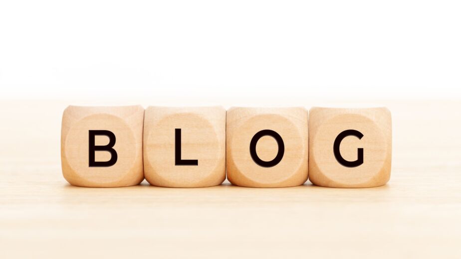 Wooden blocks with text BLOG on wood table. Copy space